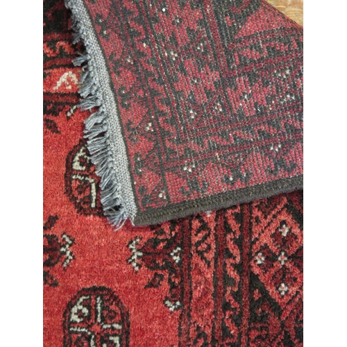 1655 - A Turkoman rug, the wine red field with two rows of quartered medallions, enclosed by a multiple geo... 