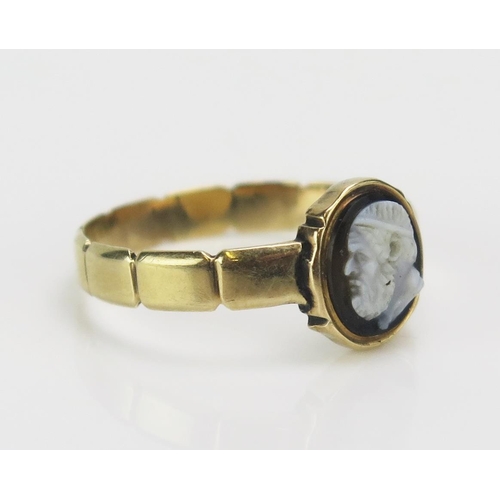 182 - A 19th Century Hardstone Cameo Ring decorated with the bust of a classical bearded man in profile in... 