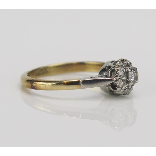 194 - An 18ct Gold and Diamond Platinum Set Cluster Ring, c. 6.7mm head, size J.25, stamped PLAT 18CT, 2.6... 