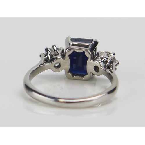 199 - An 18ct White Gold, Sapphire and Diamond Three Stone Ring, c. 8.5x6.6mm emerald cut and 4.57mm round... 