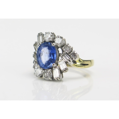 219 - An 18ct Gold, Sapphire and Diamond Cluster Ring, c. 9.1x7.4mm pale blue principal stone, surrounded ... 