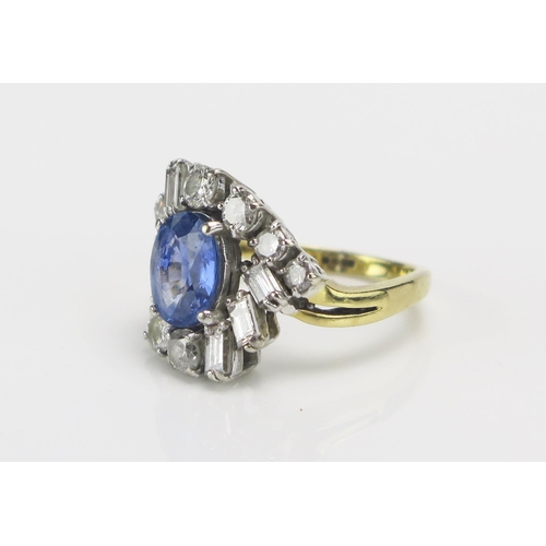 219 - An 18ct Gold, Sapphire and Diamond Cluster Ring, c. 9.1x7.4mm pale blue principal stone, surrounded ... 