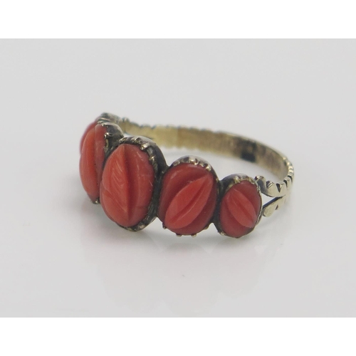 220 - A Georgian Coral Ring carved with leaf decoration and, size J, in a precious yellow metal setting, s... 