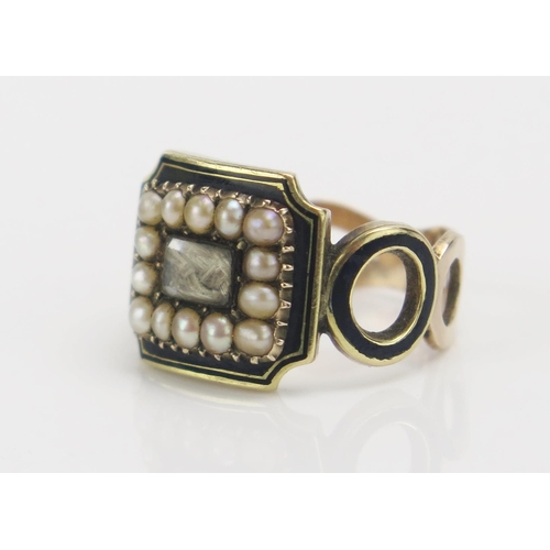 249 - A Georgian Memorial Ring with a central panel of platted hair with a border of split pearls, further... 