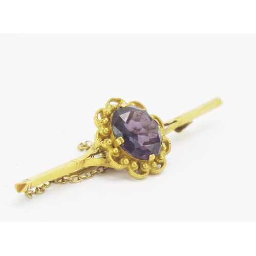 26 - A 23K Gold and Amethyst Brooch, 56.2mm, stamped 23K, 7.73g