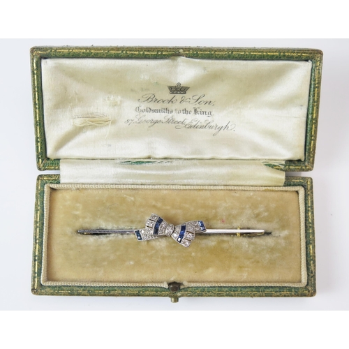 285 - A 15ct Gold, Sapphire and Diamond Platinum Millegrain Set 'Bow Tie' Brooch, 63.9mm, stamped 15C PT, ... 