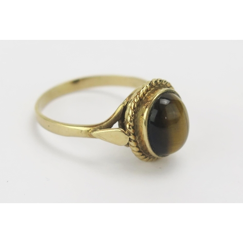 46 - A 9ct Gold and Cabochon Tiger's Eye Ring, size Q.5, hallmarked, 3.81g