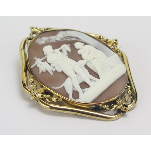 5 - A Victorian High Carat Gold Shell Cameo Brooch decorated with a lady with babe and a man in a romant... 