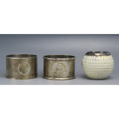 501 - Two silver napkin rings, various makers and dates, and a silver mounted match striker in the form of... 