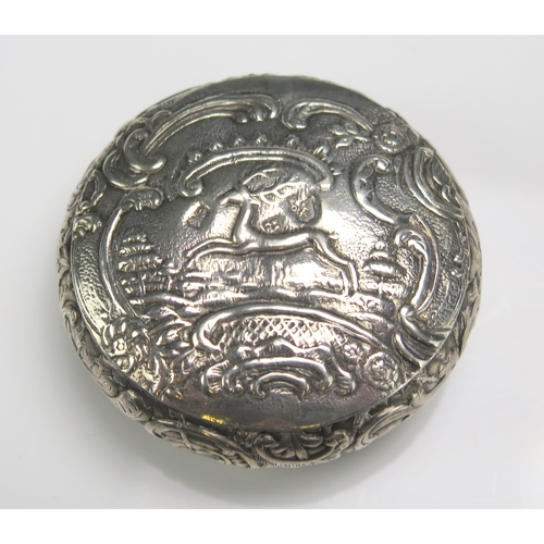 527 - A continental silver circular snuff box, stamped marks, decorated with a prancing stag, 6cm diameter... 