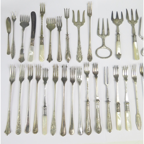 549 - A cpo0llection of silver plated flatwares including pickle forks, ham forks, silver mounted comb, et... 