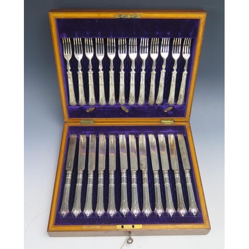 588 - A set of twelve plated fruit knives and matching forks, contained in a mahogany case.