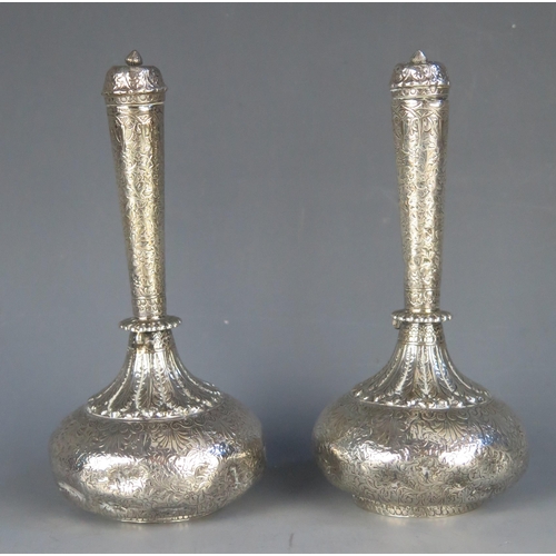 665 - A pair of Indo-Persian silver rose water bottles of traditional design with all over foliate decorat... 