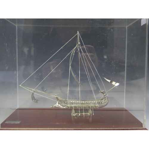 696 - A silver model of a Greek trireme war vessel, with two rows of oars and square sale, 20cm long mount... 