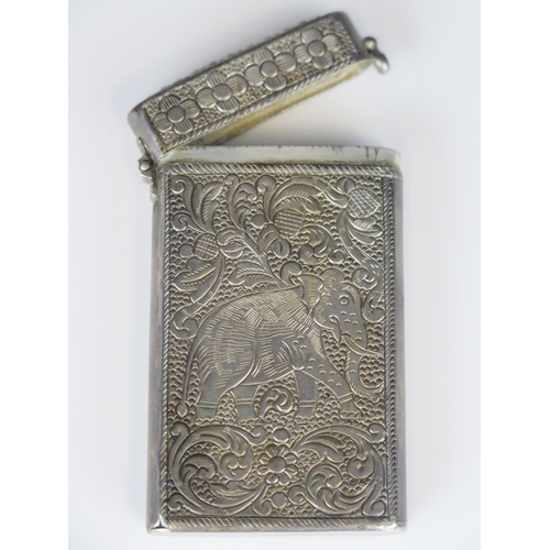 698 - An Indian silver rectangular card case, with hinged lid, having elephant and floral decoration, 7.5c... 