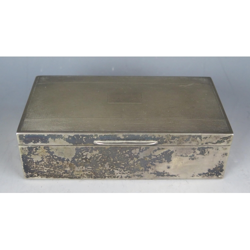 712 - A continental silver cigarette box, stamped marks, of rectangular outline, with engine turned decora... 