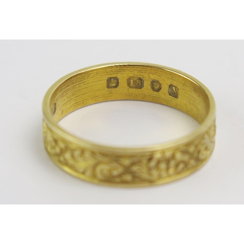 76 - A Victorian 18ct Gold Wedding Band with chased foliate decoration, c. 4.8mm wide, size N, London 187... 