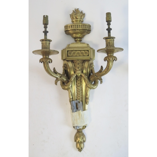 1316 - A pair of Empire style gilt brass twin branch wall lights, surmounted with flaming urns on a taperin... 