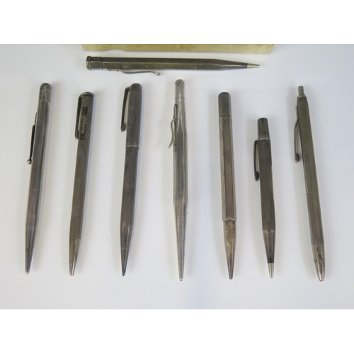 12 - A collection of eight assorted silver propelling pencils, various makers and dates.