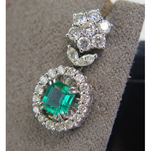 1 - A Pair of 18K White Gold, Emerald and Diamond Pendant Earrings with a top cluster above a suspended ... 