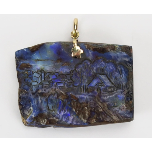 100 - A 9ct Gold Carved Bolder Opal Pendant decorated with a village scene, 41.3mm wide, stamped 375, 27.8... 