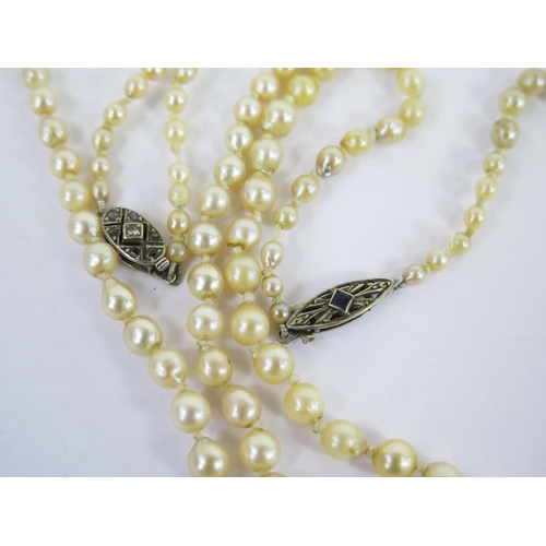 107 - Two Pearl or Cultured Pearl Necklaces, both with precious white metal clasps, one set with diamonds ... 