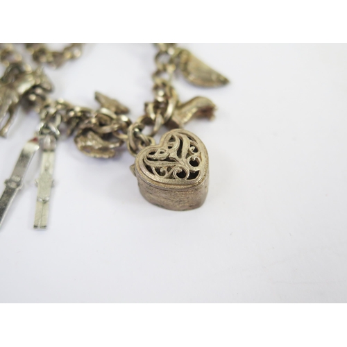 117 - A Boxed Silver Hinged Bangle with chased foliate decoration, silver charm bracelet, silver gate ling... 