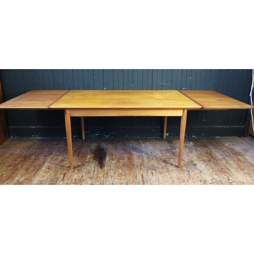 1339 - A Sibast Danish teak extending dining table, the rectangular top with two spare leaves, raised on tu... 