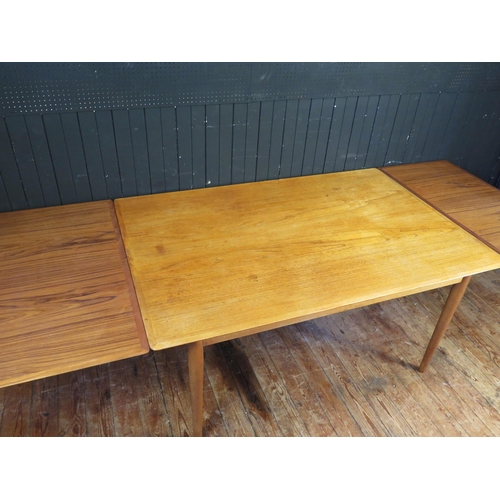 1339 - A Sibast Danish teak extending dining table, the rectangular top with two spare leaves, raised on tu... 