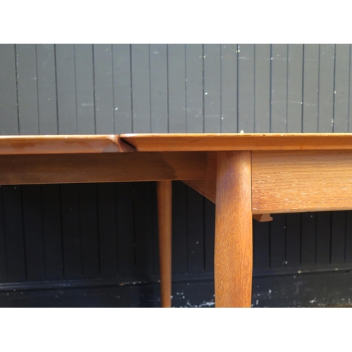 1339 - A Sibast Danish teak extending dining table, the rectangular top with two spare leaves, raised on tu... 