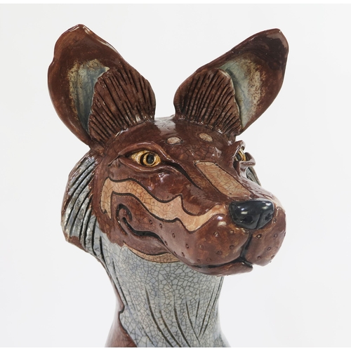1342 - Jennie Hale (British 1956-) a large raku fired studio pottery sculpture of a seated wolf, signed to ... 