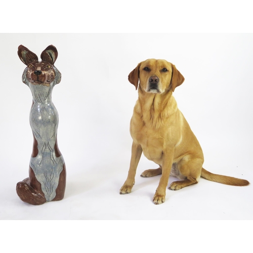 1342 - Jennie Hale (British 1956-) a large raku fired studio pottery sculpture of a seated wolf, signed to ... 