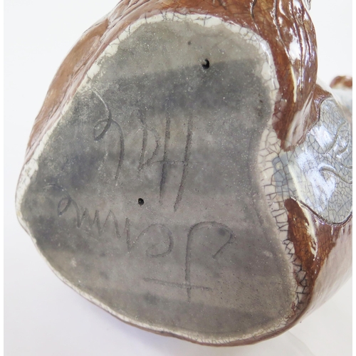 1342 - Jennie Hale (British 1956-) a large raku fired studio pottery sculpture of a seated wolf, signed to ... 