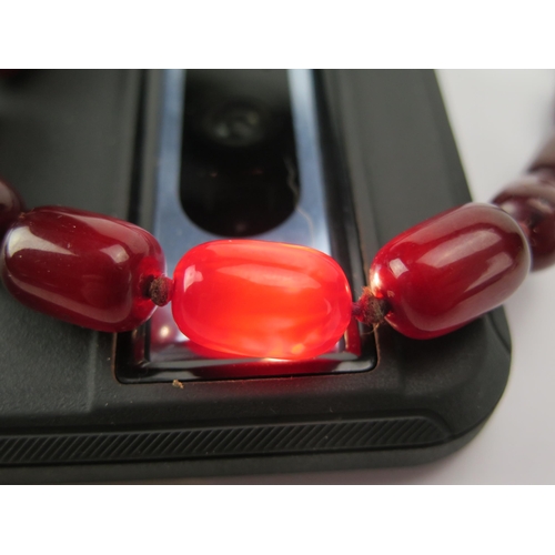 202 - A Faux Cherry Amber Bead Necklace, c. 80cm, largest bead c. 18.7x12.2mm, 59.94g