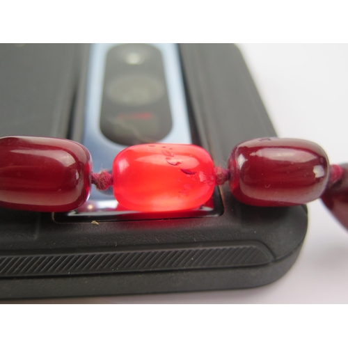 202 - A Faux Cherry Amber Bead Necklace, c. 80cm, largest bead c. 18.7x12.2mm, 59.94g