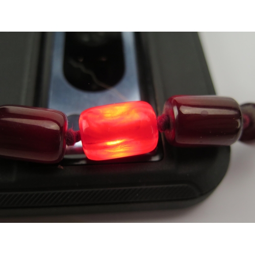 202 - A Faux Cherry Amber Bead Necklace, c. 80cm, largest bead c. 18.7x12.2mm, 59.94g