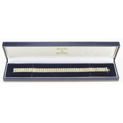 234 - A 9ct Gold and Diamond Bracelet set with 200 brilliant round cuts, 20cm, 11.6mm wide, CCM mark, 23.9... 