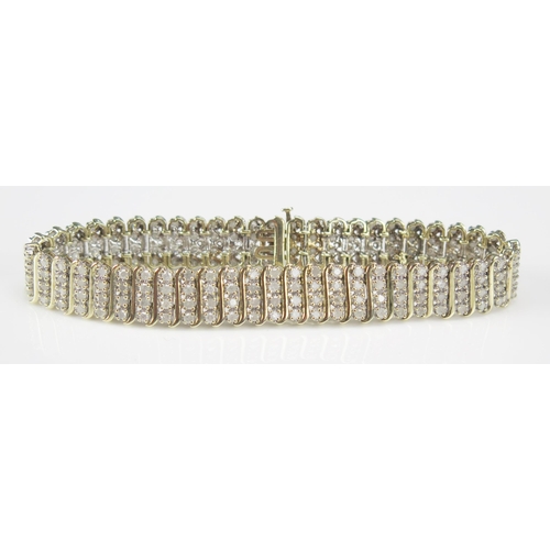 234 - A 9ct Gold and Diamond Bracelet set with 200 brilliant round cuts, 20cm, 11.6mm wide, CCM mark, 23.9... 