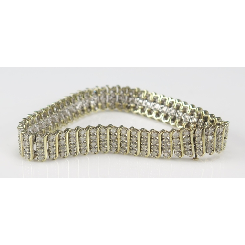 234 - A 9ct Gold and Diamond Bracelet set with 200 brilliant round cuts, 20cm, 11.6mm wide, CCM mark, 23.9... 