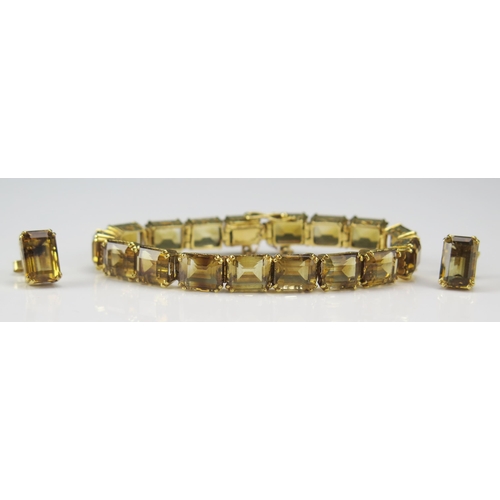 241 - A Citrine Bracelet in a high carat precious yellow metal setting with a pair of matching earrings, K... 