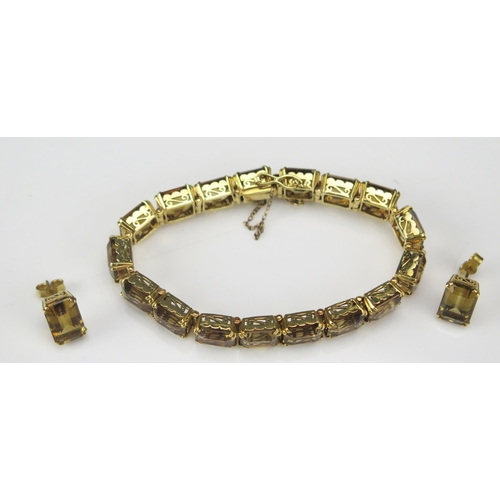 241 - A Citrine Bracelet in a high carat precious yellow metal setting with a pair of matching earrings, K... 