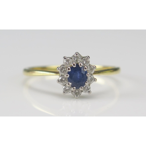 244 - An 18ct Gold, Sapphire and Diamond Cluster Ring, 9.65x8.4mm head, size T.5, hallmarked, 2.68g