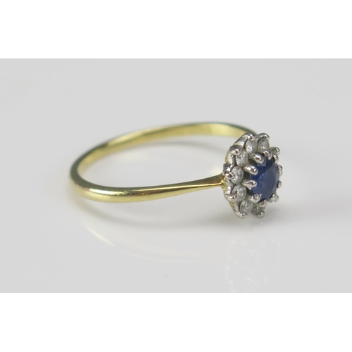 244 - An 18ct Gold, Sapphire and Diamond Cluster Ring, 9.65x8.4mm head, size T.5, hallmarked, 2.68g