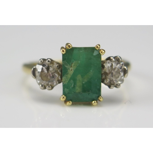 249 - An 18ct Gold, Emerald and Diamond Platinum Set Ring, c. 9x6.3mm principal stone flanked by old cuts,... 