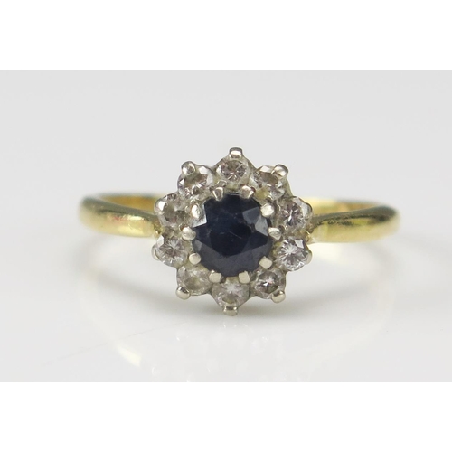 257 - An 18ct Gold, Sapphire and Diamond Cluster Ring c. 9.6mm head, size M.5, stamped 18CT, 2.52g