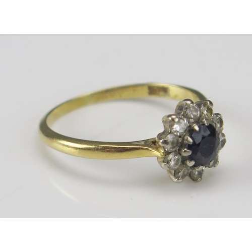 257 - An 18ct Gold, Sapphire and Diamond Cluster Ring c. 9.6mm head, size M.5, stamped 18CT, 2.52g