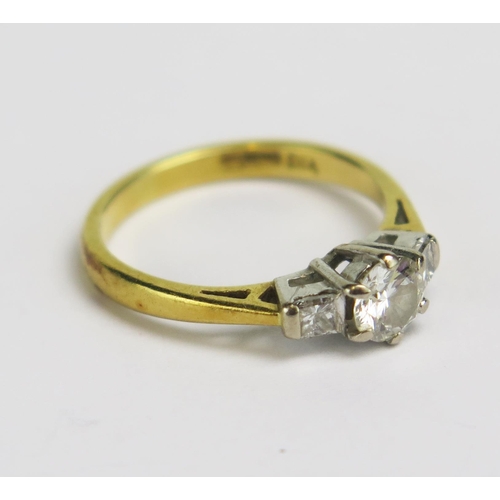 4 - An 18ct Gold and Diamond Three Stone Ring, c. 4.8mm principal stone, size J.25, hallmarked, 2.73g.

... 