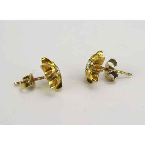 48 - A Diamond Eight Point Star Studs in a precious yellow metal setting, 10.3mm diam., c. 2.45mm stones,... 