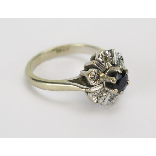 56 - An 18ct White Gold, Sapphire and Diamond Cluster Ring, c. 12.4mm head, size I.5, stamped 18CT, 6.09g