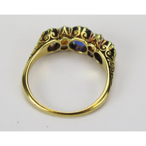 58 - An 18ct Gold, Spinel? and Diamond Seven Stone Ring, c. 5.7mm principal stone, size Q, stamped 18CT, ... 